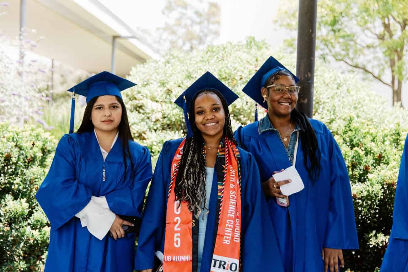 students smiling at graduation